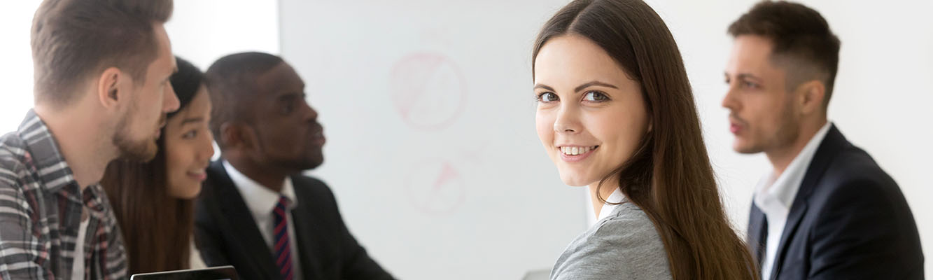 Smiling businesswoman professional or intern looking at camera a